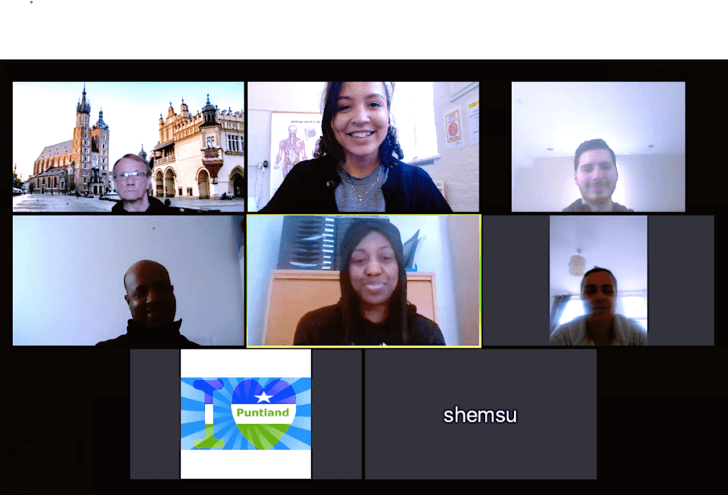 Screenshot of a Zoom video call showing eight participants of Conversation Group. Two people have their cameras off but everyone else is looking at the camera and smiling.